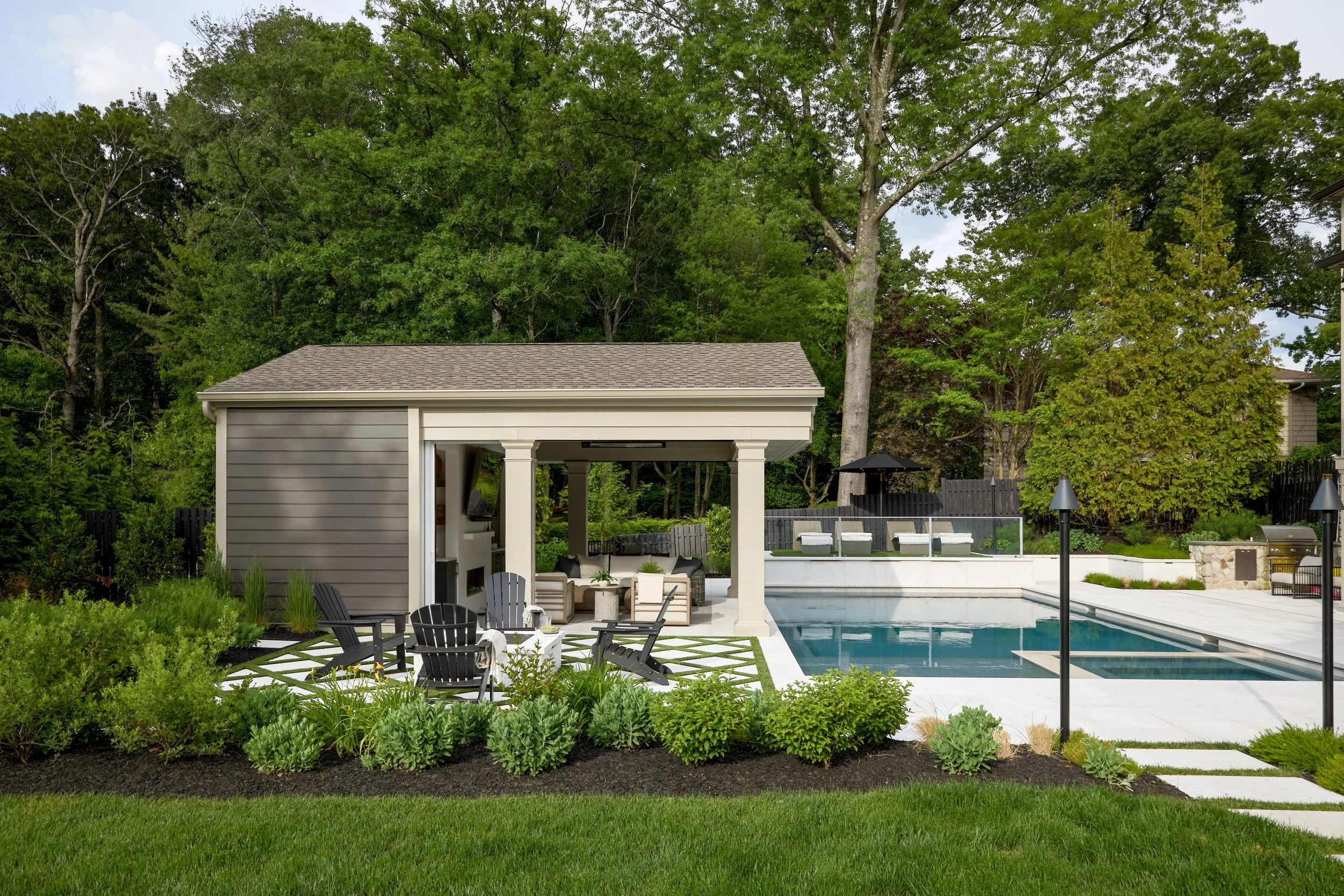 Wide view of a custom pool pavilion, swimming pool, fire-pit terrace and professionally landscaped luxury backyard in New Jersey.jpg