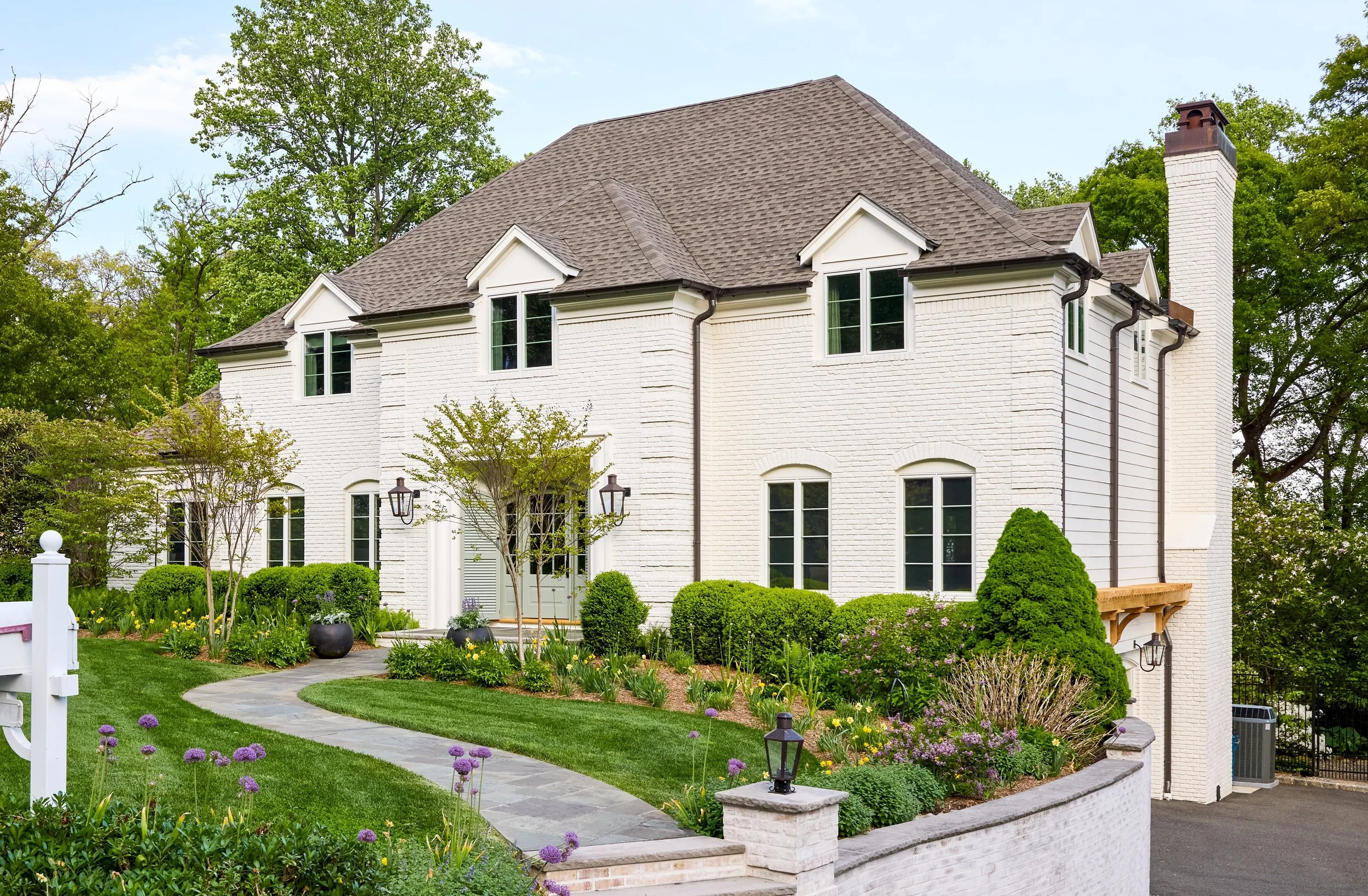 Angled view of painted brick home cedar and brass accents and slate walkway in Mountainside NJ home cropped.jpg