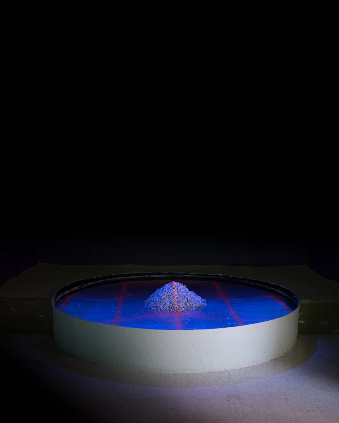 ACCESS Video Projection, White Marl Stone, Wood, Water, Sand. 8ft. in diameter. Two Channel Audio. Duration: 6:56