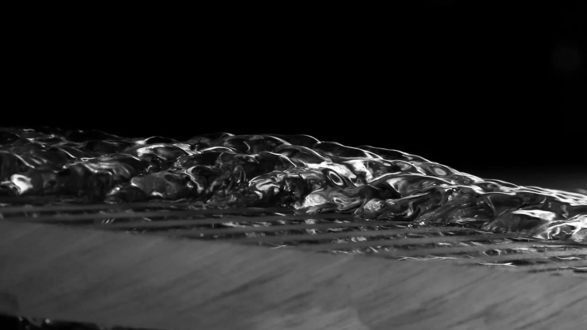 Film flow over a surface with alternating hydrophilic (dark gray) and hydrophobic (frosted white) bands.