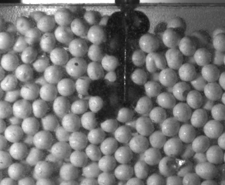 Water jet injected via a syringe into a porous, particulate medium