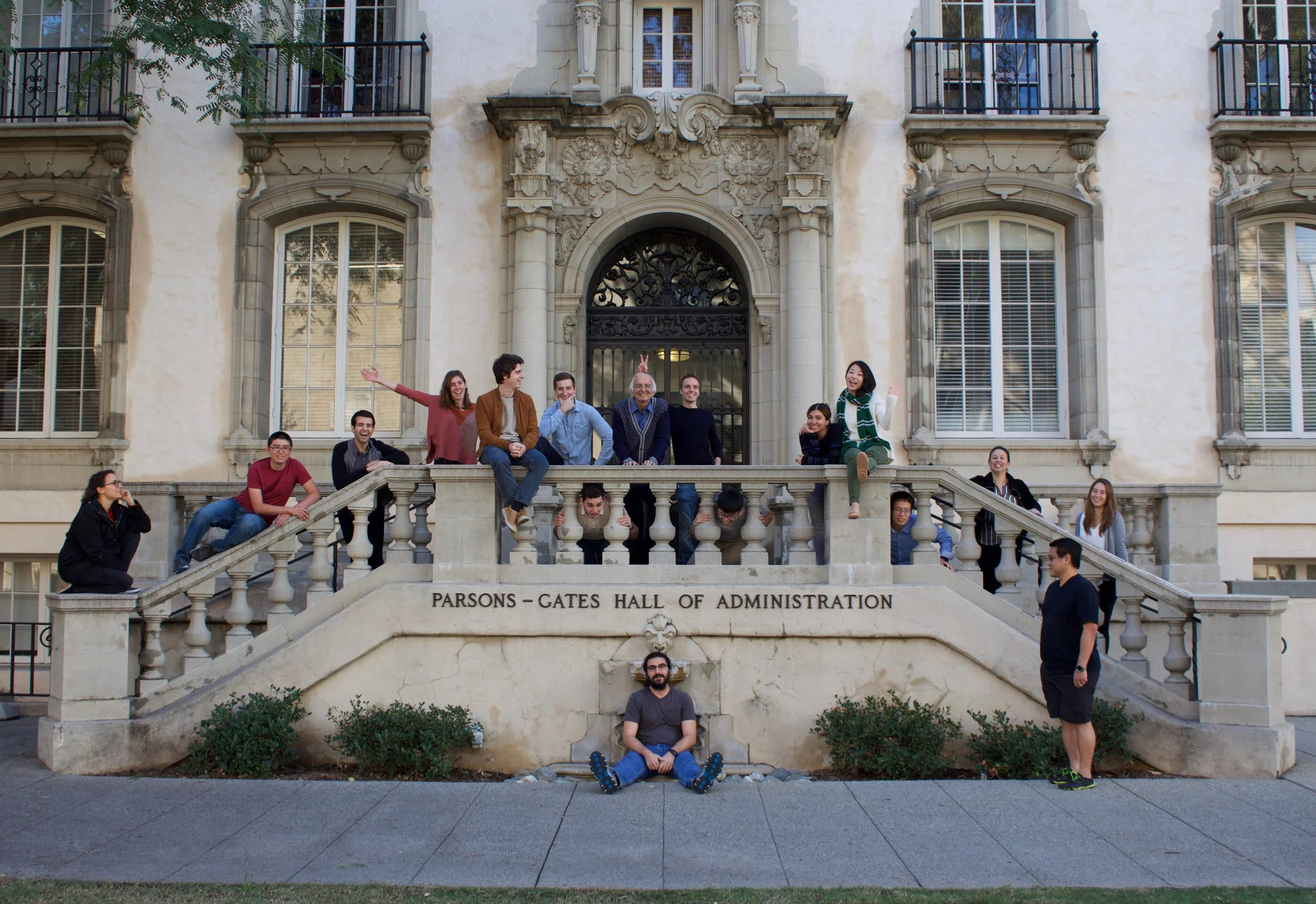In front of Caltech's Hall of Administration! Sitting on the floor: Manu. Staring at Manu: David J. Head between the balusters (left to right): Chris D., Chris R., and Cong. On the stairs (left to right): Morgane, Nathan, David M., Stephanie, Raimondo, Marcel, Masoud, Damian, Azin, Jinglin, Martha, Cecilia. Photo credit: Kali Dougherty from Kali Jeane Photography.