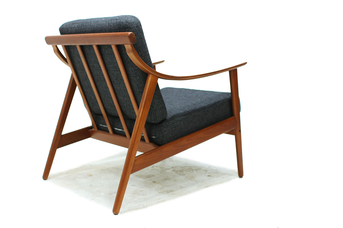 1960's Danish Designer Teak Wood Lounge Chair With Sculpted Armrests and Dark Gray Cushions Designed by Arne Hovmand Olsen