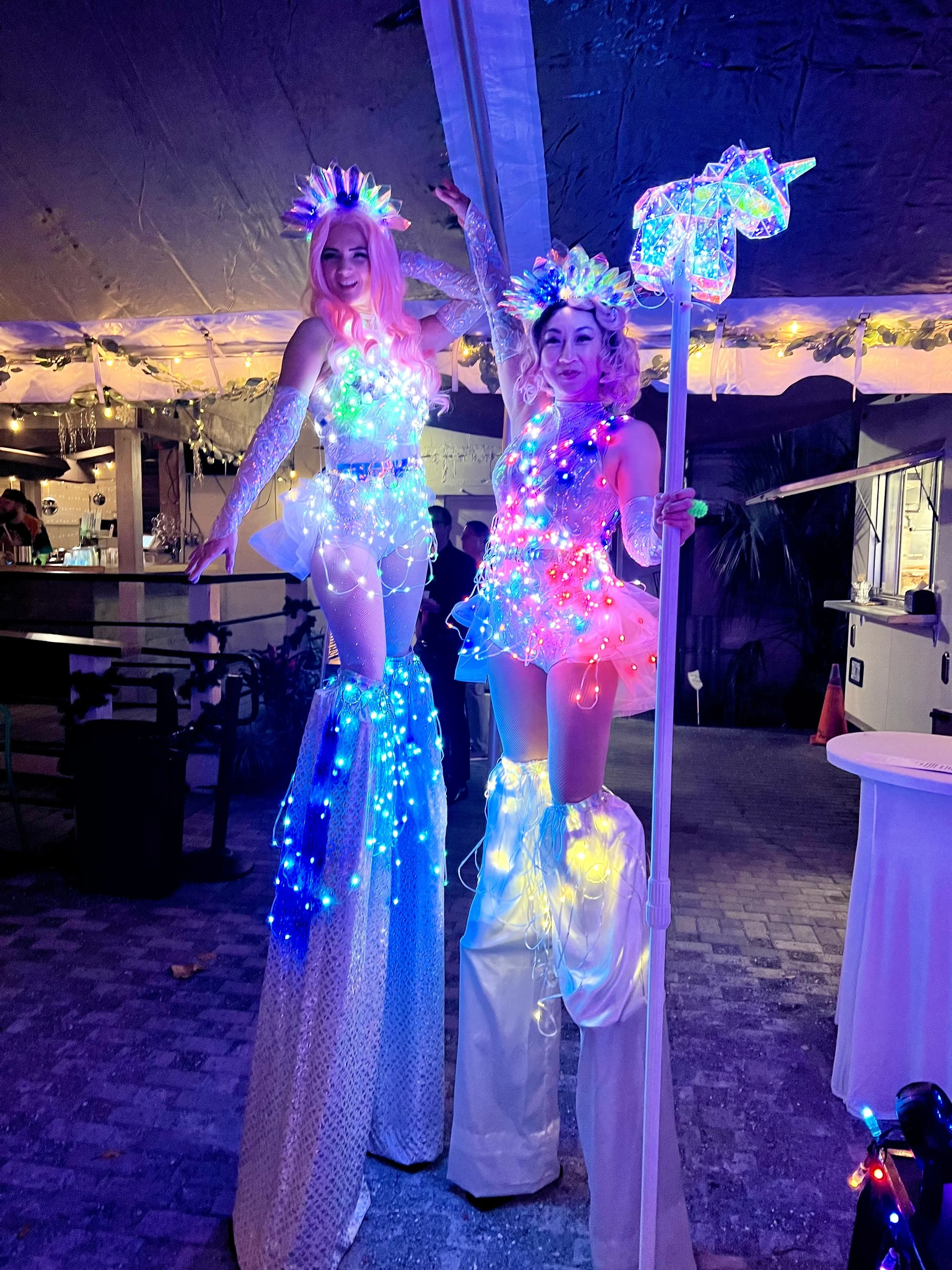 LED stilt walkers in light up costumes