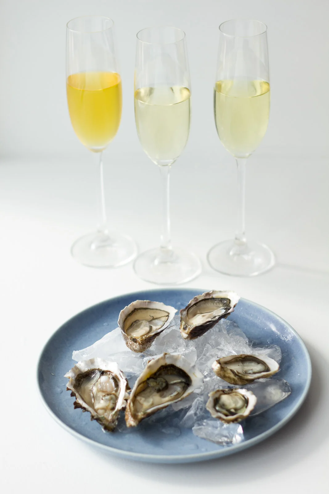 In the flute glasses (from left to right): Gunpowder Temple of Heaven, Mao Feng, Tamaryokucha. Oysters - Bottom left: Sweetwaters. Bottom right: Kumamoto. Center: Chelsea Gems.