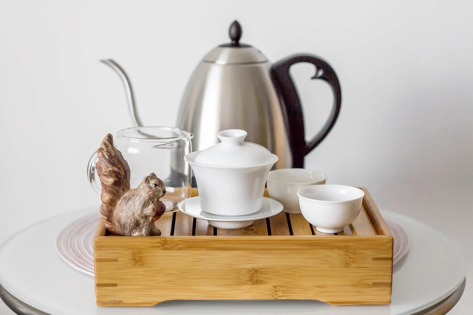 My gong fu tea tray with my gaiwan, tasting cups, serving pitcher, tea pet and variable temperature kettle. Basic but functional.