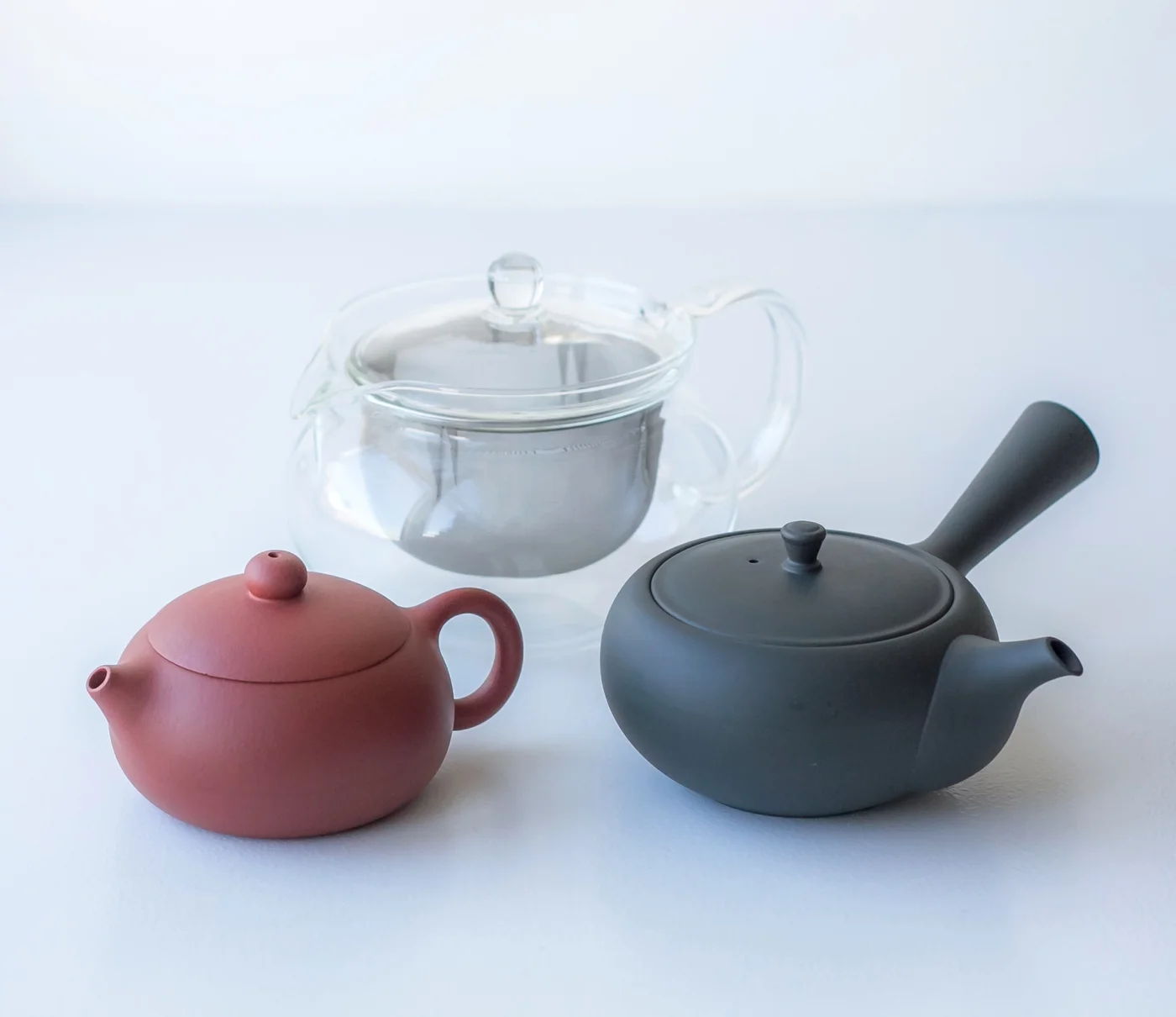 My beloved tea pots: small yixing tea pot (left), Western style glass tea pot (center) and Japanese kyusu (right).