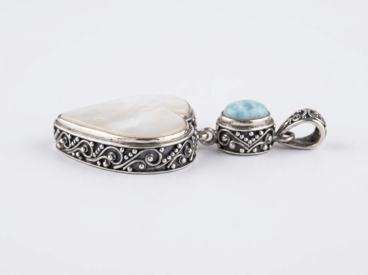 Mother of Pearl heart and Larimar sterling silver pendant showing ornate artisan silverwork