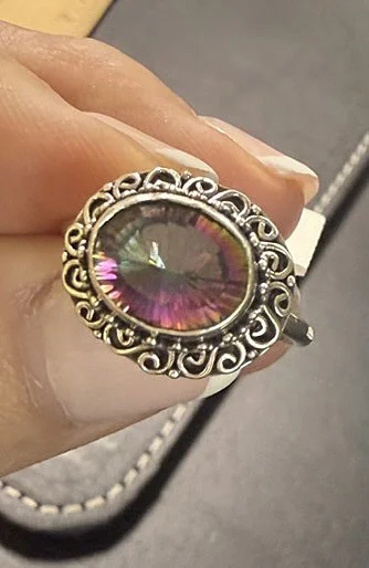 Sterling silver Mystic Topaz ring with iridescent gemstone and ornate scrollwork, handcrafted by artisans in Bali