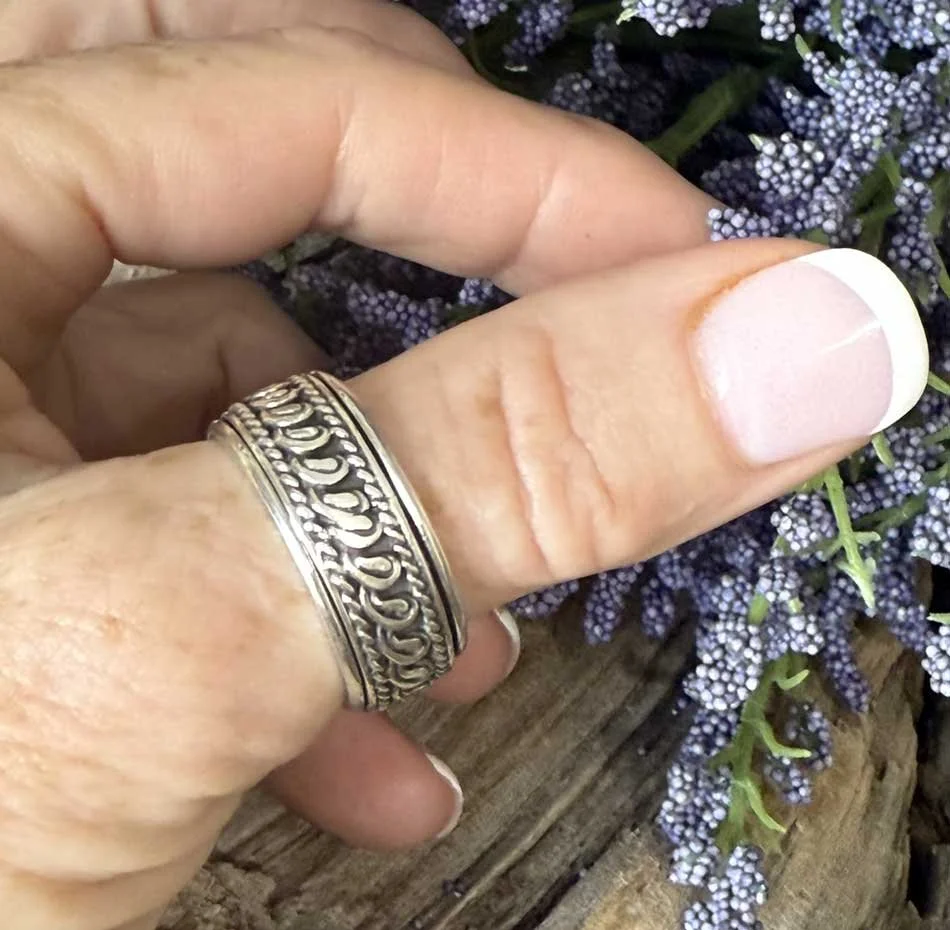 Sterling silver Tibetan prayer wheel spinner ring with intricate scrollwork, handmade in Bali for mindfulness and anxiety relief