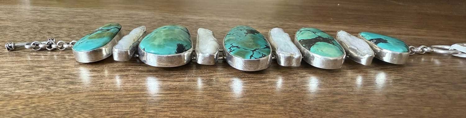 Handmade sterling silver turquoise and pearl adjustable bracelet featuring natural gemstones and artisan design. Boho chic jewelry crafted with elegance and meaning.