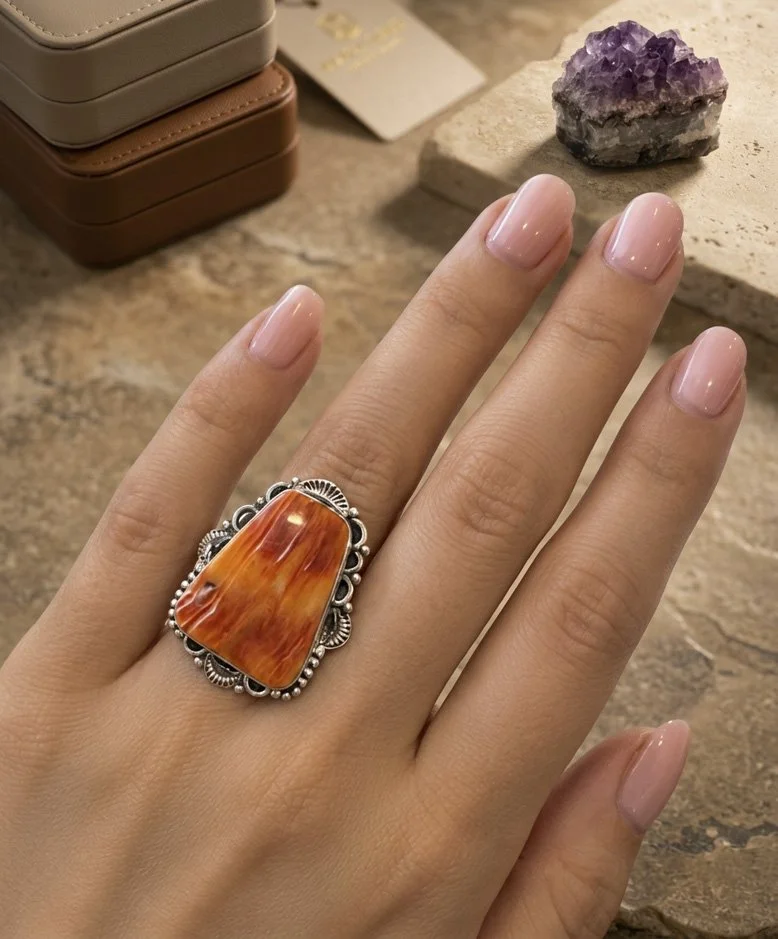 Orange spiny oyster sterling silver statement ring shown on hand, one-of-a-kind artisan jewelry from Chantek Designs.