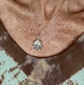 Sterling silver lotus charm necklace, perfect for bohemian and yoga style.