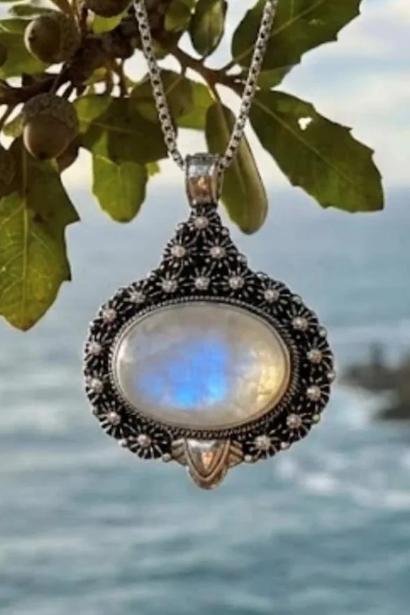 Sterling silver moonstone pendant with large luminous center stone