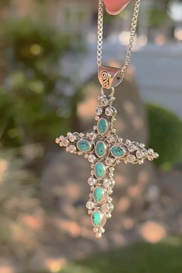 Sterling silver cross pendant with ocean-blue turquoise and zircon gemstones, handmade in Bali