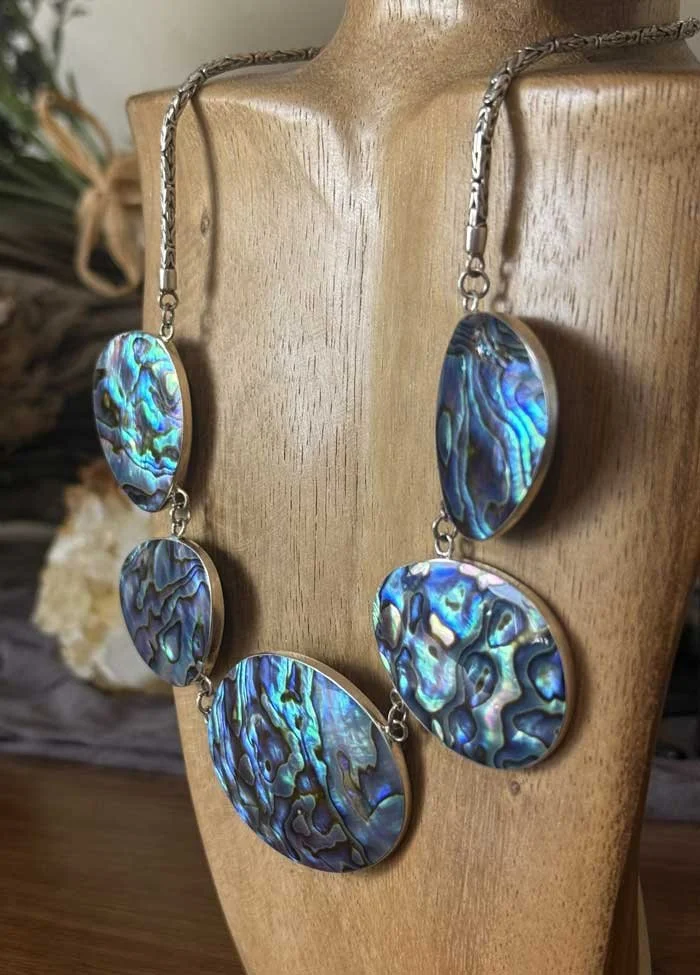 Handcrafted sterling silver abalone shell necklace with luminous ocean colors. Artisan statement jewelry inspired by the sea and handmade in Bali.