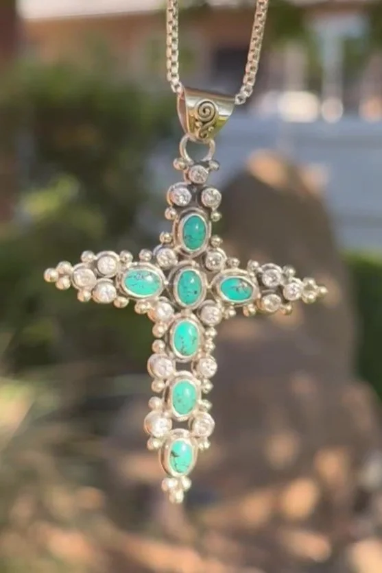 Sterling silver cross pendant with ocean-blue turquoise and zircon gemstones, handmade in Bali