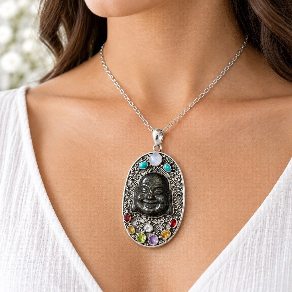 Model wearing a large oval obsidian Buddha gemstone pendant necklace with a white top
