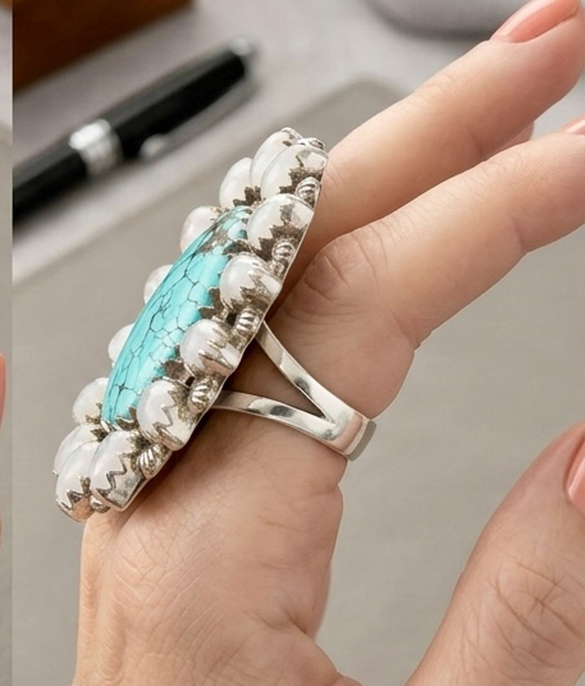 Side view of turquoise and moonstone halo ring handcrafted in sterling silver artisan statement ring with natural gemstones
