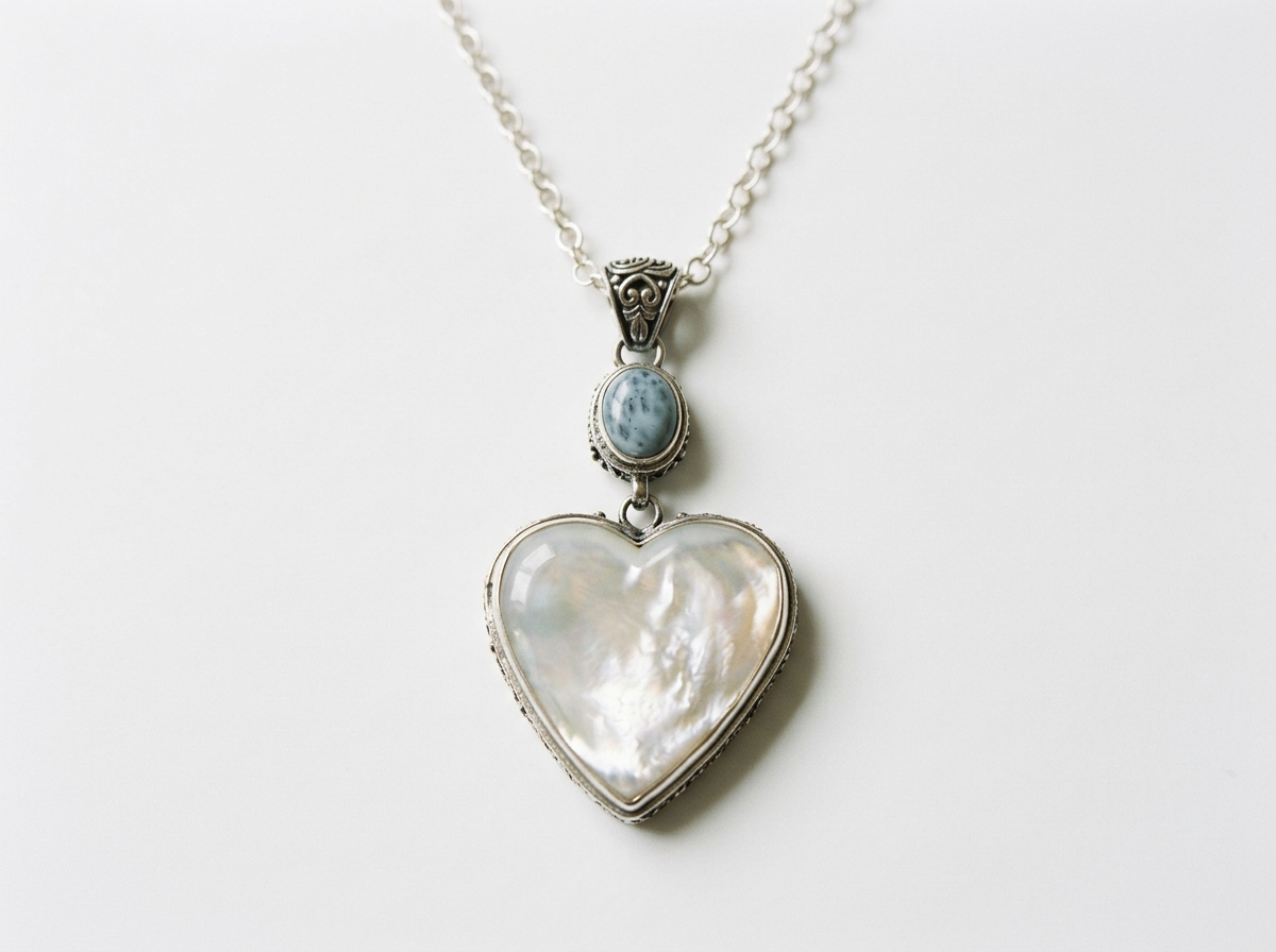 Close-up of natural Mother of Pearl heart and Larimar gemstone sterling silver pendant