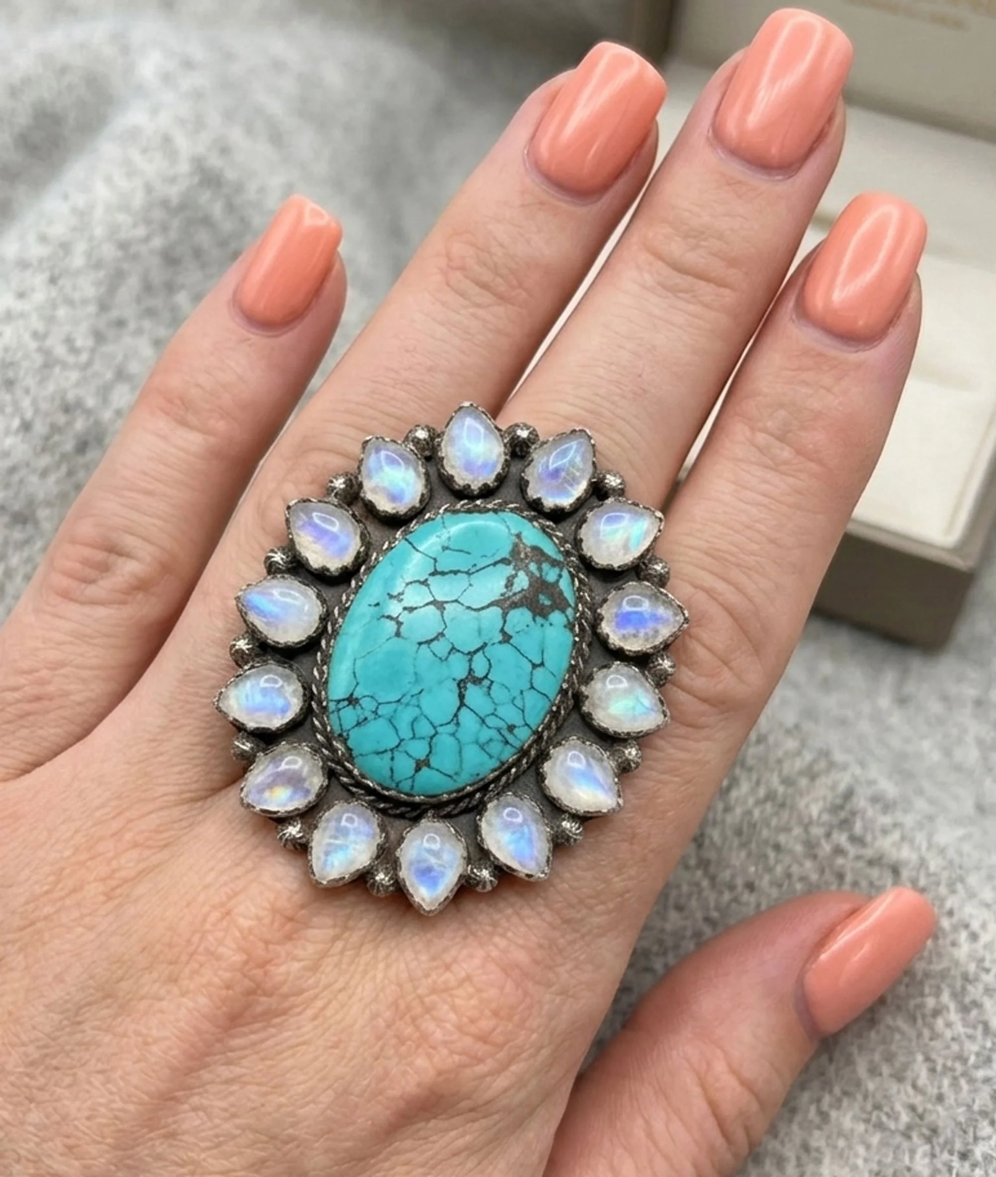 Turquoise and moonstone halo statement ring in sterling silver on hand featuring natural turquoise center stone and moonstone gemstones