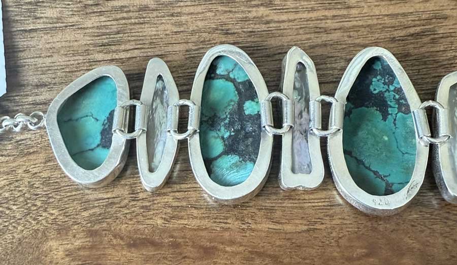 Handmade sterling silver turquoise and pearl adjustable bracelet featuring natural gemstones and artisan design. Boho chic jewelry crafted with elegance and meaning.