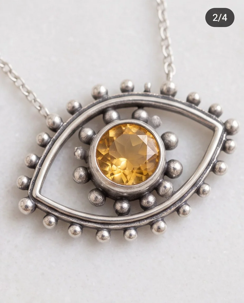 Detailed view of a faceted golden citrine gemstone surrounded by decorative sterling silver beadwork.