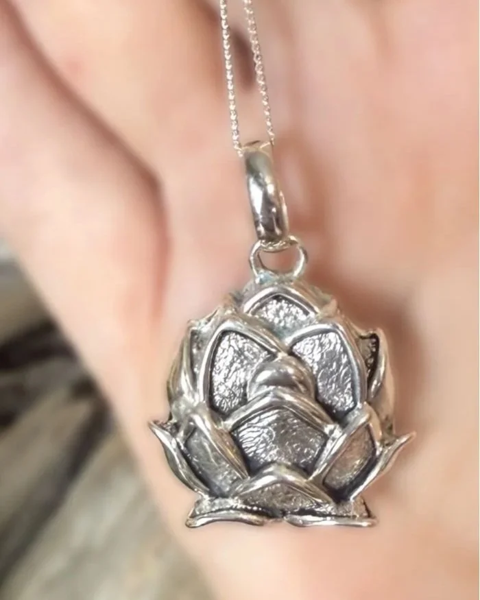 Artisan-crafted sterling silver lotus necklace, meaningful spiritual jewelry.