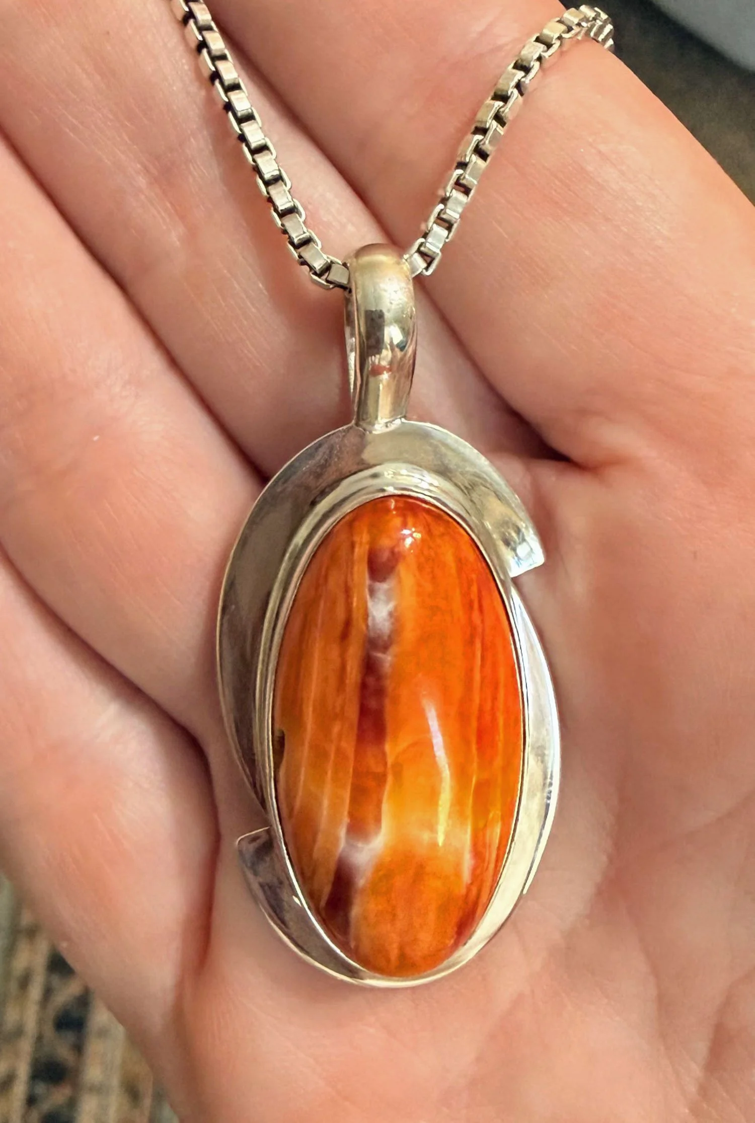 Orange Spiny Oyster Shell pendant in sterling silver with natural cream and copper banding.