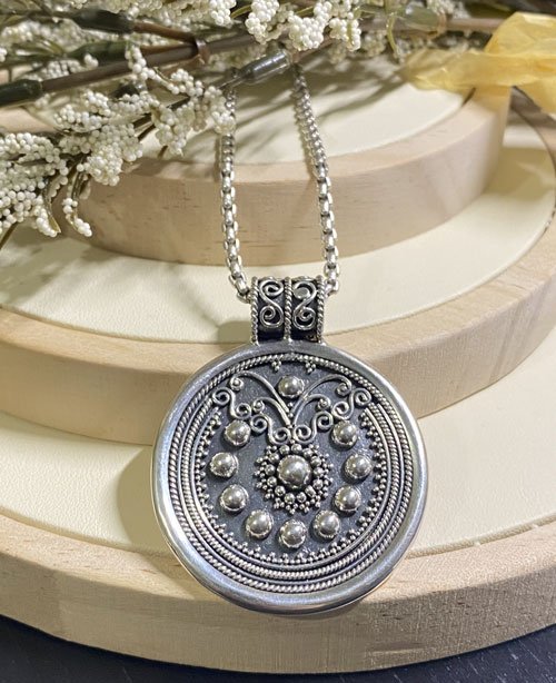 silver pendant, Balinese jewelry, granulation design, handcrafted, sterling silver, sunburst pendant, traditional craftsmanship, circular medallion, artisan jewelry, intricate details