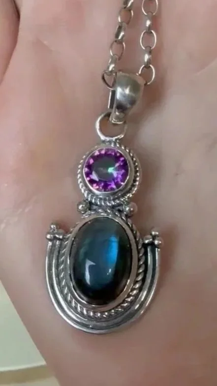 Handcrafted sterling silver pendant featuring luminous labradorite & sparkling amethyst. Unique Boho artisan design from Bali.