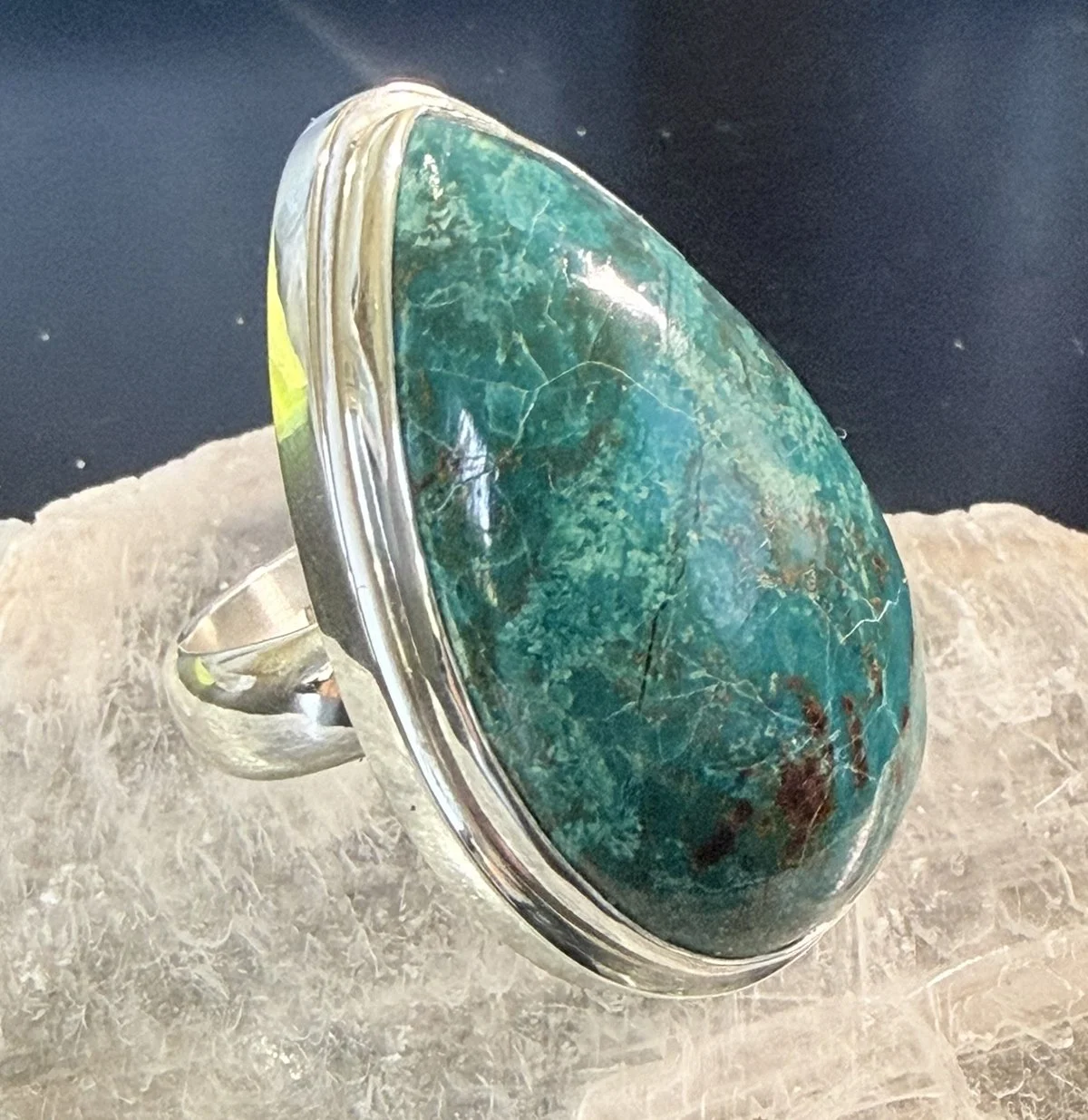Close-up of natural Chrysocolla sterling silver statement ring with large teardrop blue-green gemstone