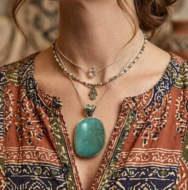 Large natural turquoise cabochon pendant set in sterling silver on layered boho necklaces