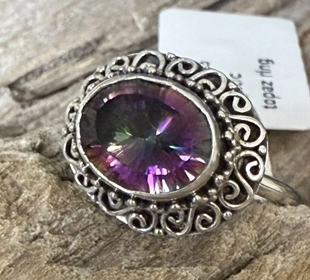 Sterling silver Mystic Topaz ring with iridescent gemstone and ornate scrollwork, handcrafted by artisans in Bali