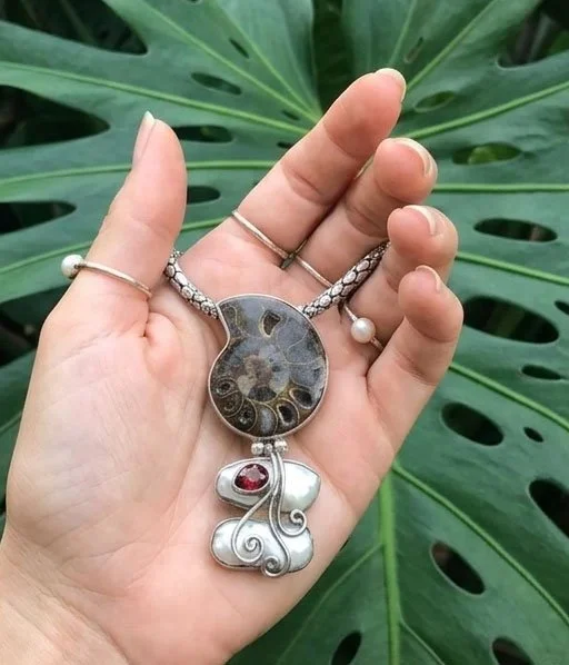 Ammonite fossil pearl garnet statement pendant close up sterling silver handcrafted jewelry