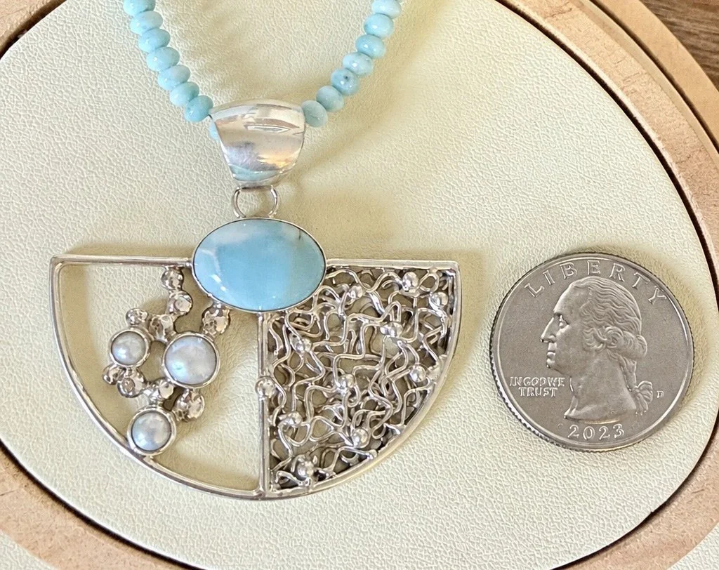 Larimar and freshwater pearl sterling silver pendant shown with a quarter for size reference.