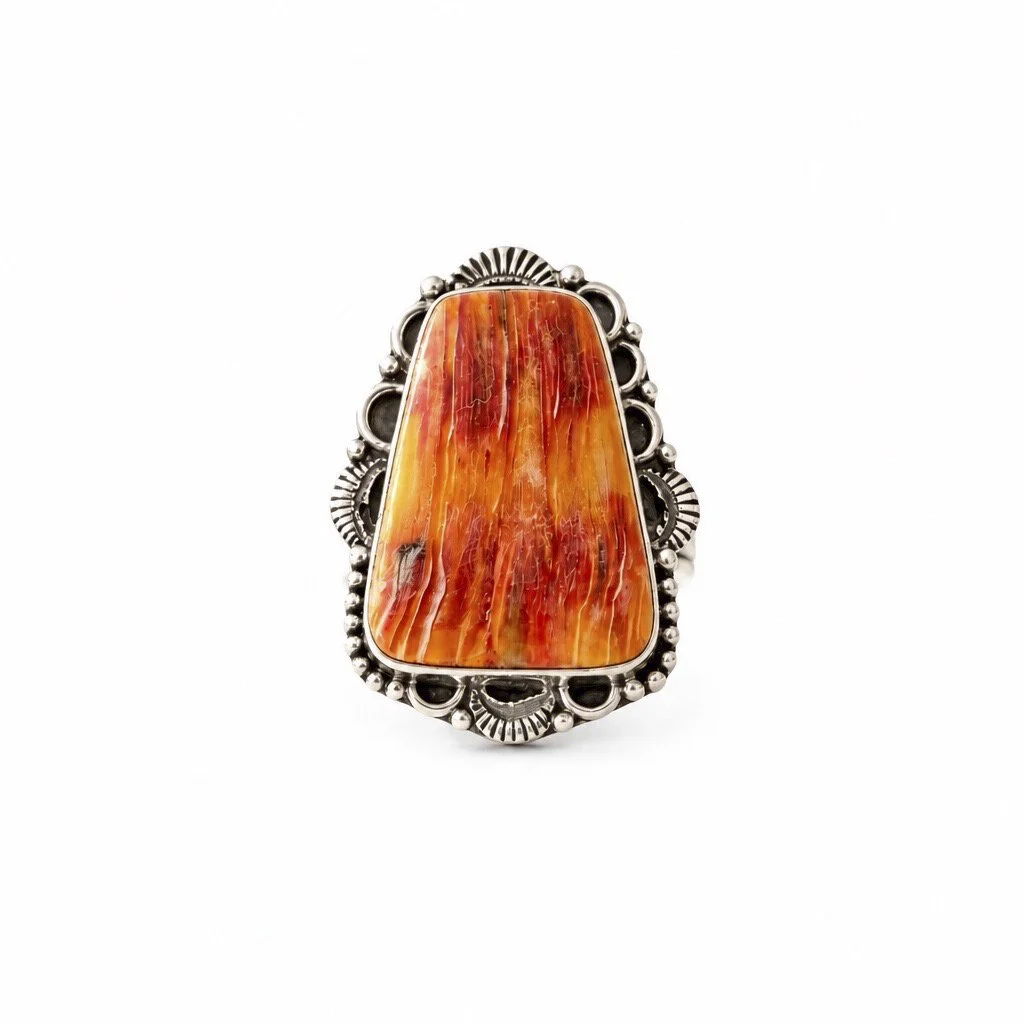 Natural orange spiny oyster statement ring in detailed sterling silver with coral, rust and golden shell patterns.