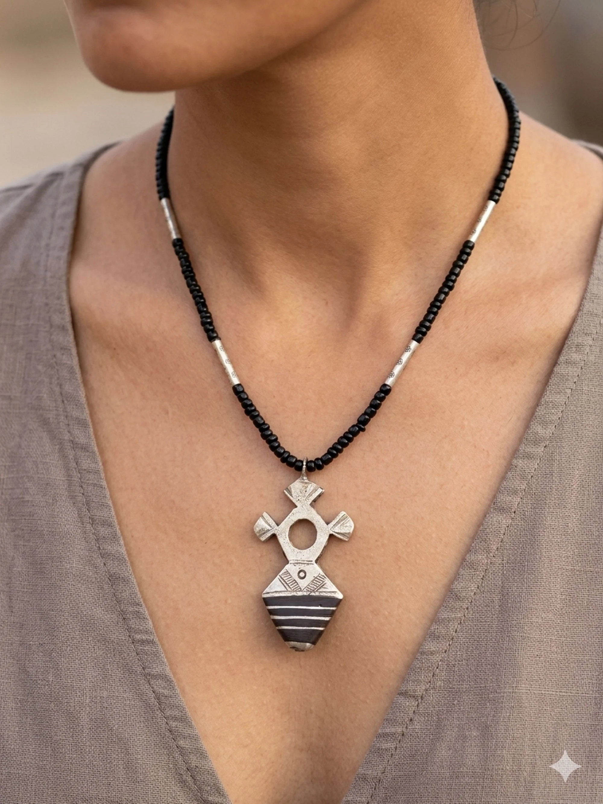 Woman wearing Moroccan Tuareg Cross pendant necklace.