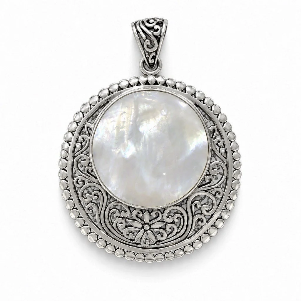 Mother of Pearl side of reversible sterling silver pendant with intricate handcrafted Bali silver detailing