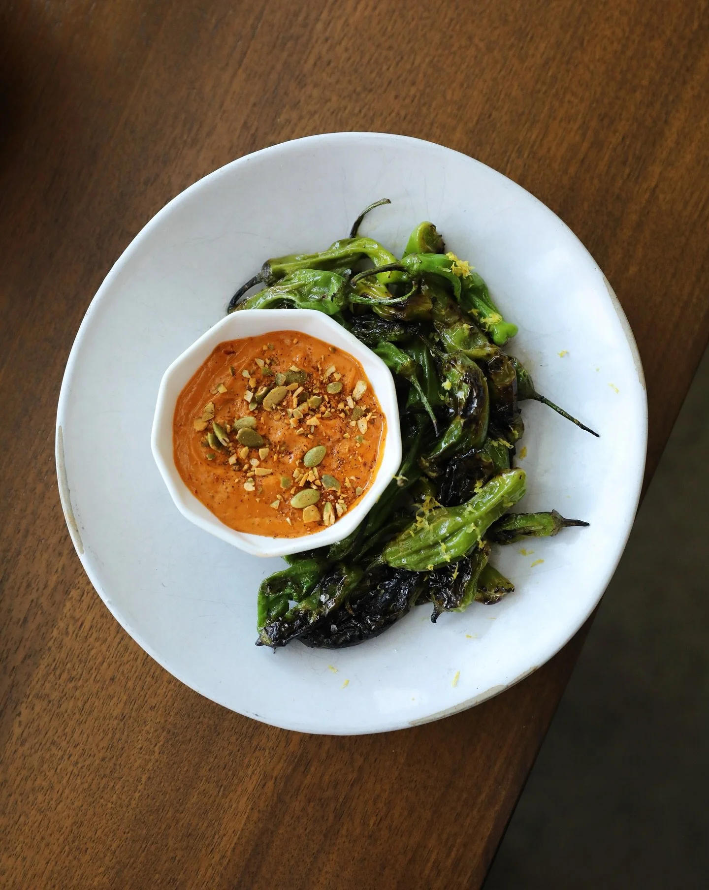 Shishito happens... but we're not complaining though. 😉

Delicious grilled shishitos hit on our grill for a beautiful smoky char and paired with a spicy aioli.