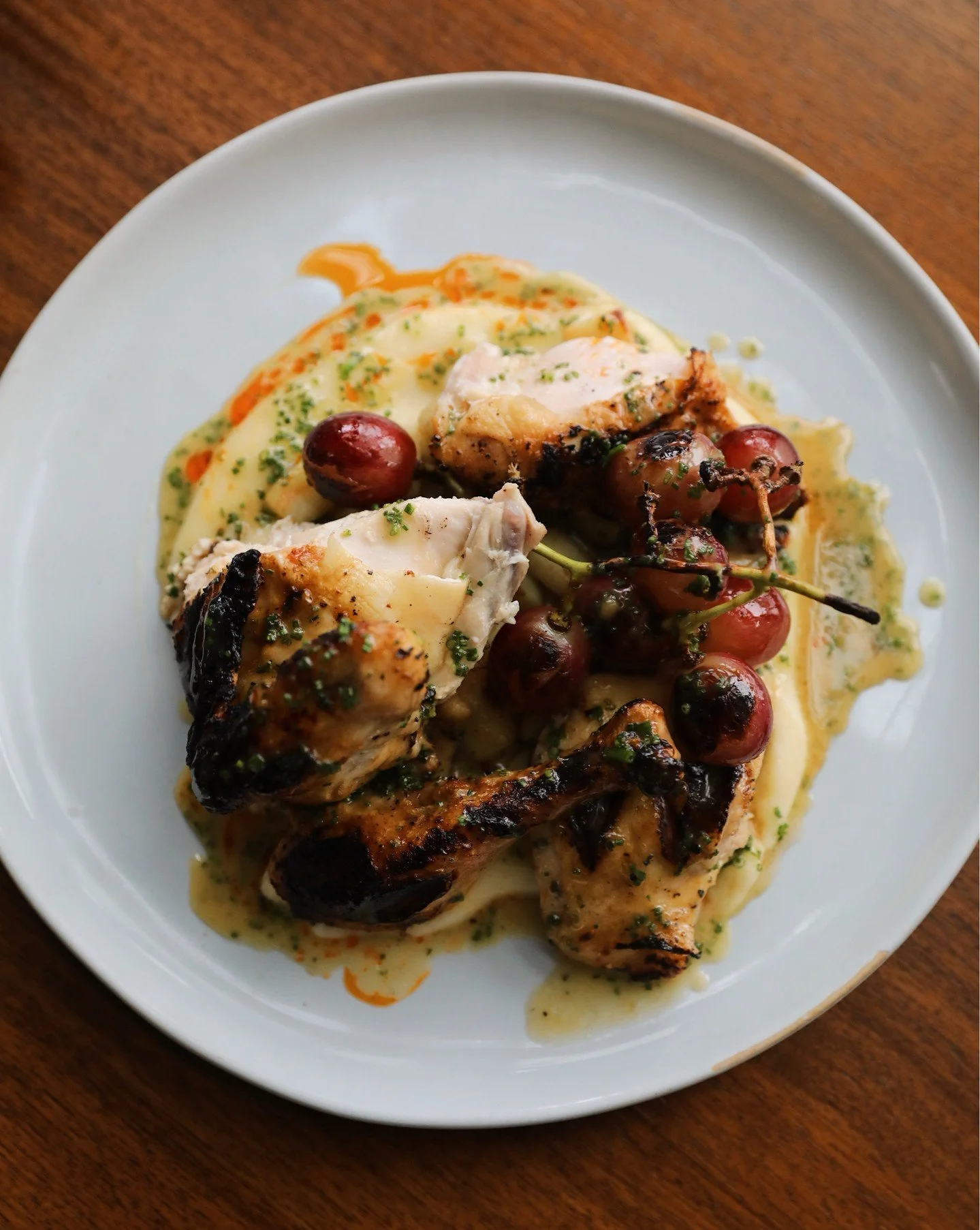 Bird's eye view of the delicious roasted half chicken, which has quickly become a favorite among regulars.

Roasted beercan style for extra juiciness, the half chicken sits on a pomme puree, finished with a chicken jus, and then finished with blister