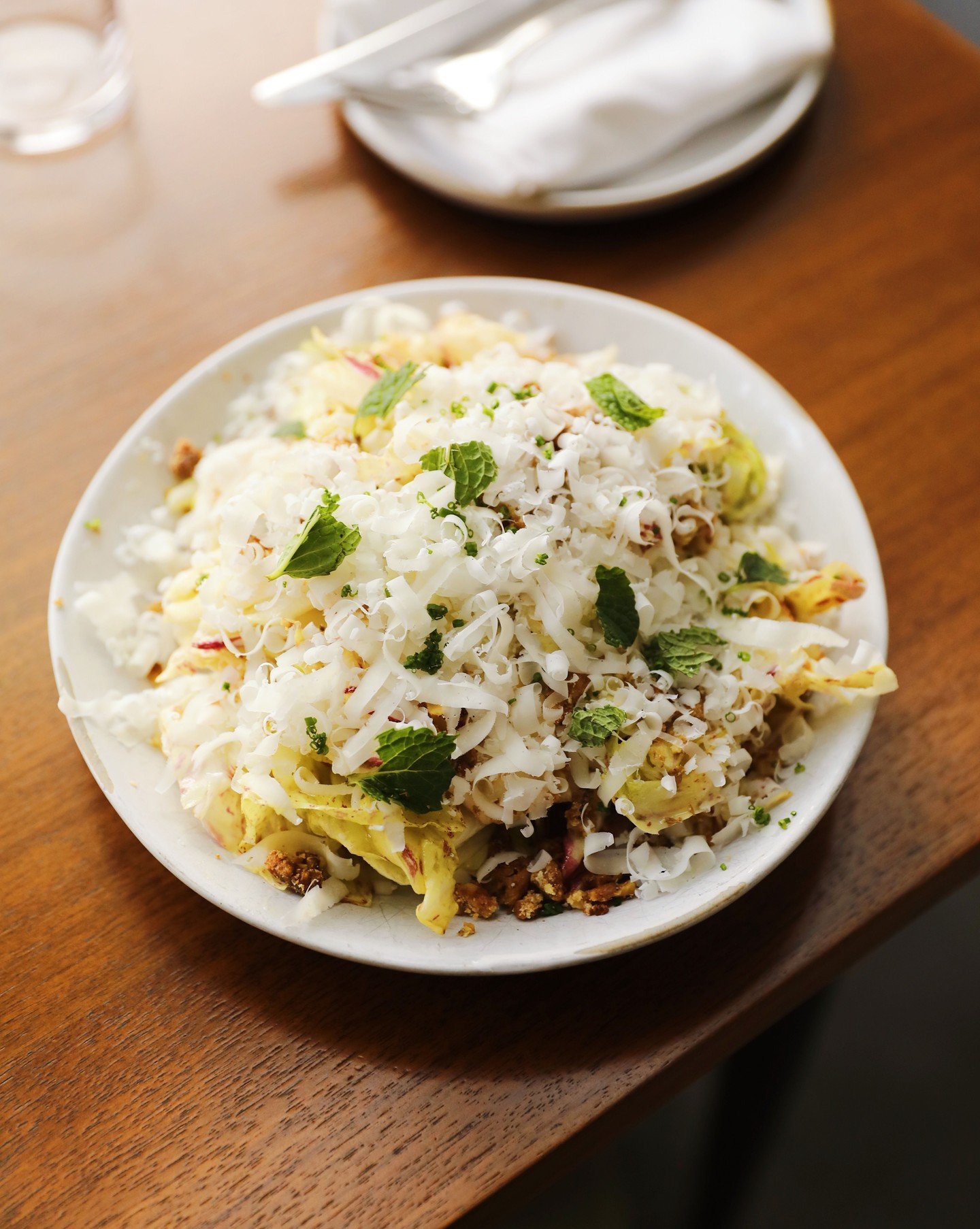 Chicory Salad. Topped with a sweet apple vinaigrette, candied walnuts, chopped herbs and a healthy amount of parmesan.

A refreshing sharable starter for the night. Now on the menu for fall! 🍂