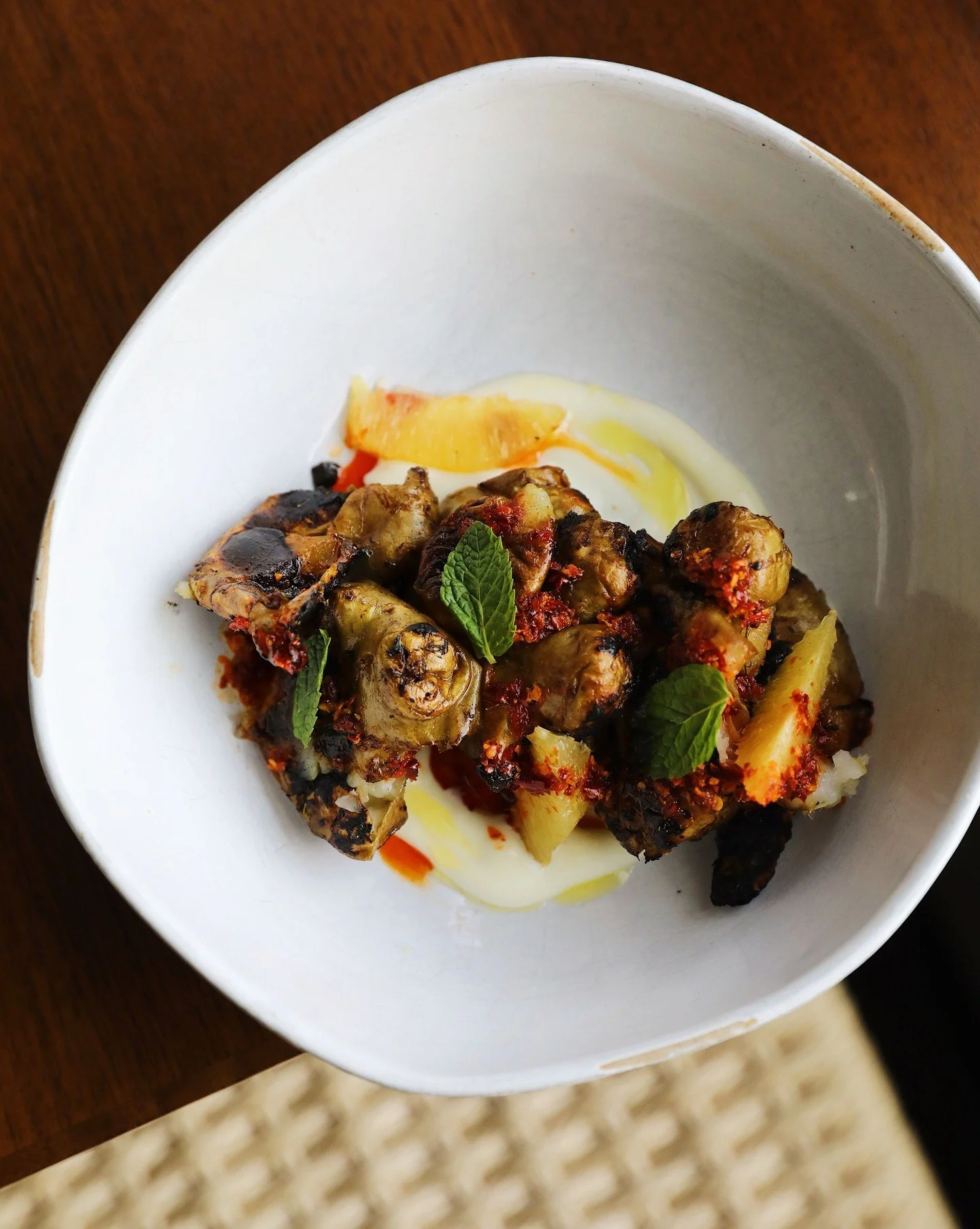 A medley of flavors and colors on a plate. Charred sunchokes, garnished with chili-garlic crisp, softened by garlic aioli, and finished with fresh mint.

See you in this weekend folks!