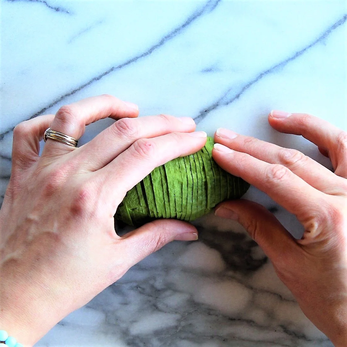 Slowly and gently, starting on your dominant hand side, begin to fan out the slices as shown.