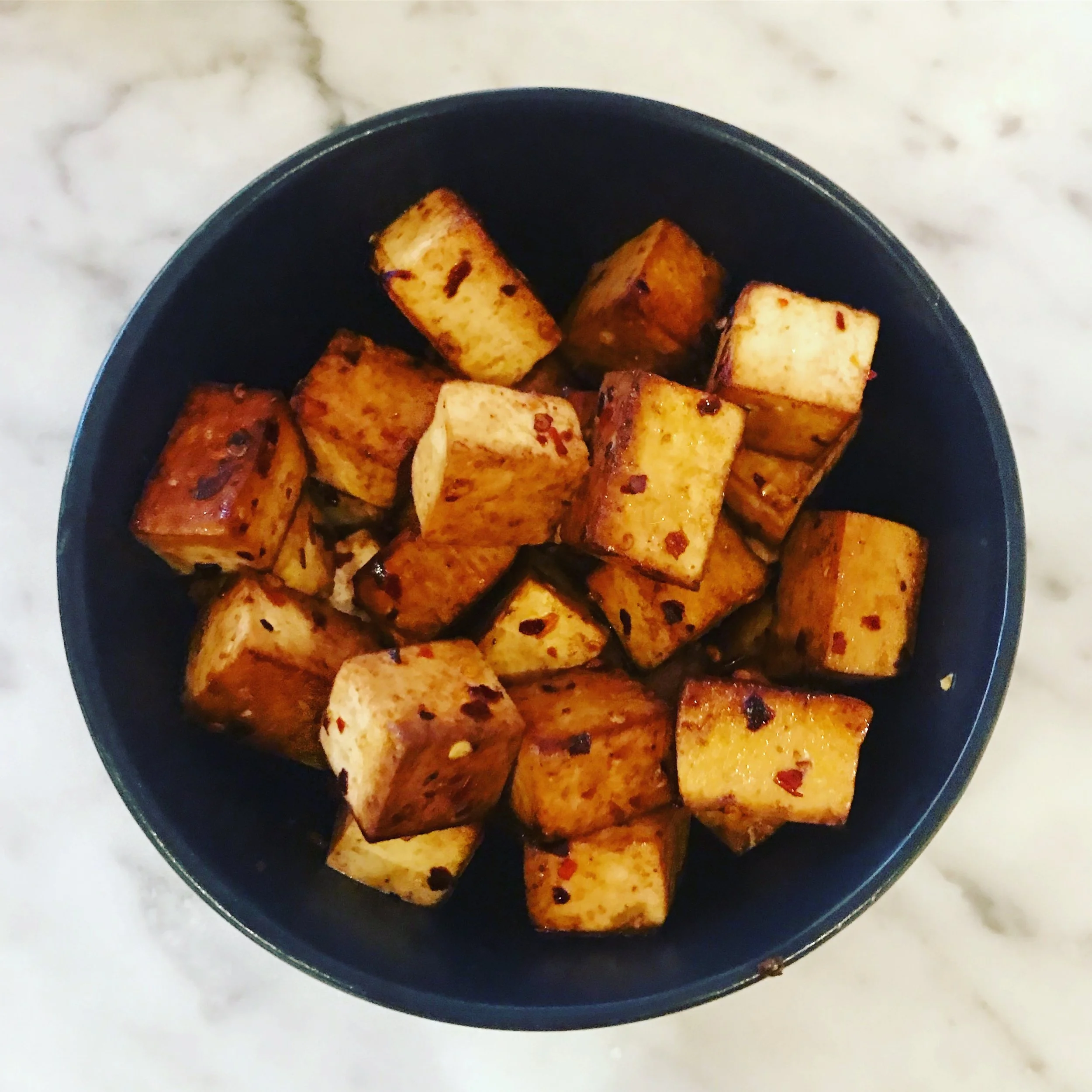 Cooked tofu with chilli flakes.