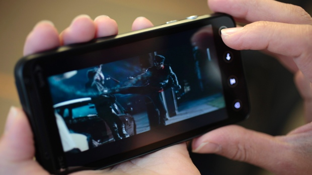 Shot of phone from over the shoulder in the barber chair watching the youtube clip of Assassin