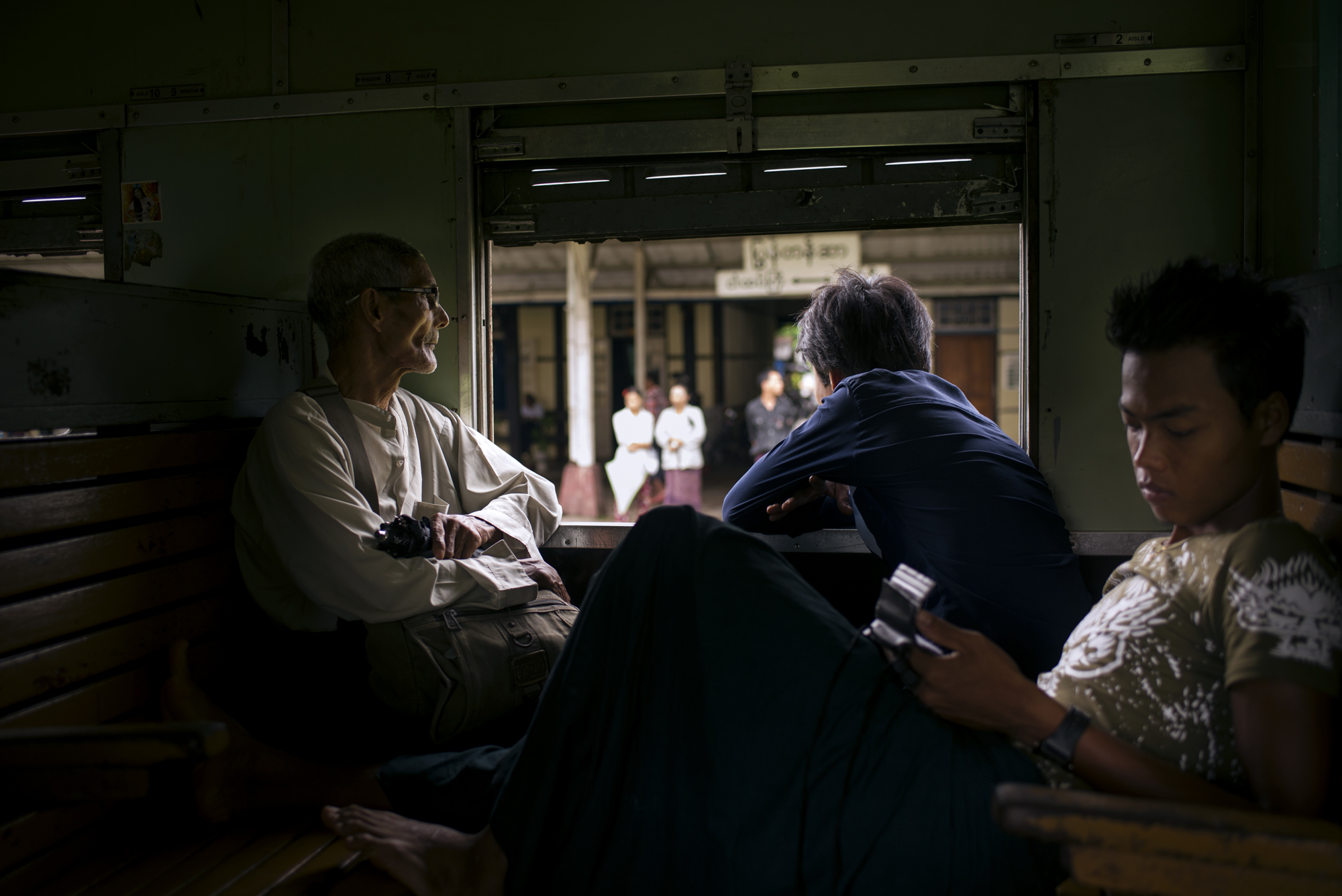 A family gets comfortable as the train departs Yangon on an the 18 hour journey up the country to Mandalay