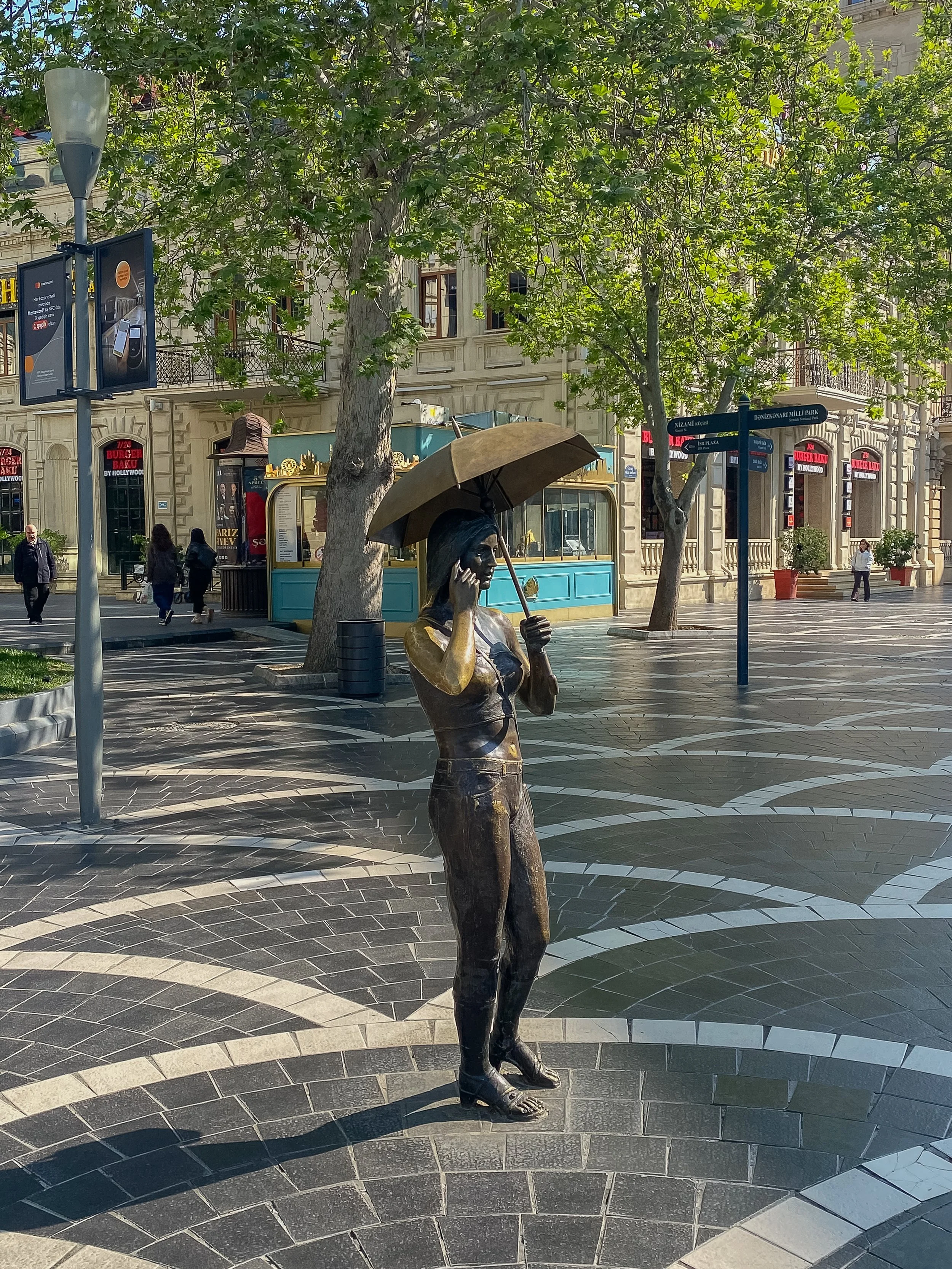  “Girl With Umbrella”  one of many statues in Fountains Square known for its charming, life-sized bronze statues depicting modern everyday life. 