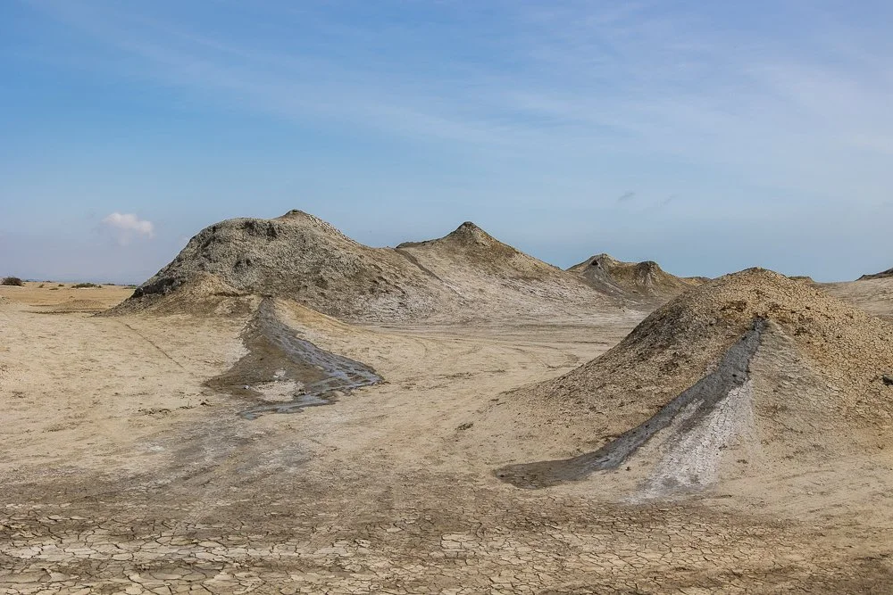   Mud Volcanoes  Nearly half the world's mud volcanoes are concentrated here, about 80 km southwest of Baku. Cool mud bubbles up through pale cracked earth in slow, indifferent eruptions.  