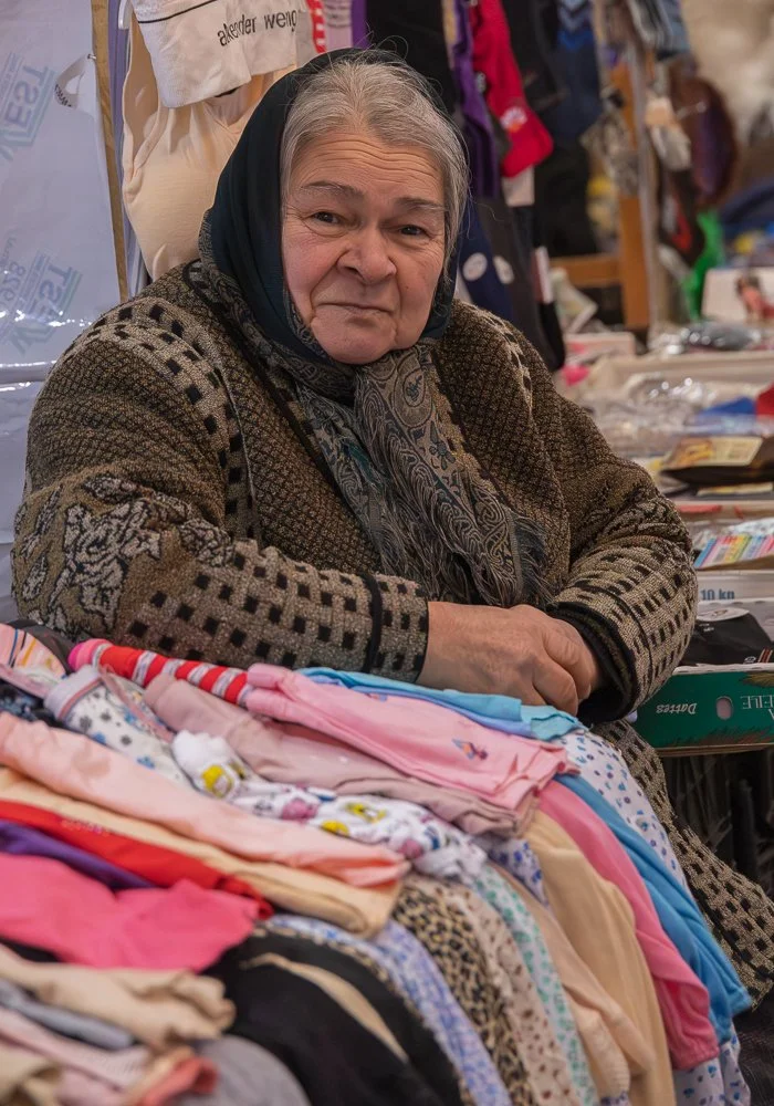   Sheki Market  Taza Bazaar on a rainy Tuesday. Covered sections for spices, nuts, meat, and fish; hundreds of vegetable stalls outside; pickled vegetables in jars of every colour. I ask before photographing. The women directed me toward the men. The